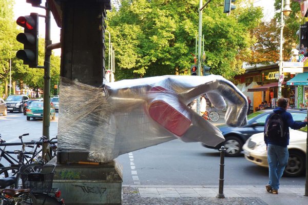 Bosso Fataka make urban art with a sense of humor. Shaking Hands on a Berlin street. hoto: Courtesy of the artists